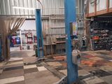 a picture of a garage with a checkered floor and a blue lift