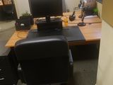 a desk with a computer and a monitor on it