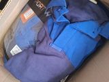 a cardboard box with a blue shirt inside of it