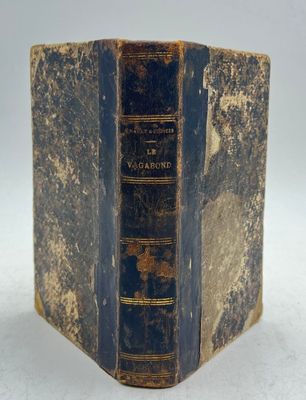 an old book sitting on top of a white surface