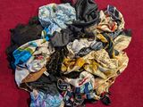 a pile of clothes that is on a red surface