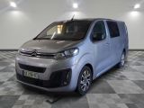the silver van is parked on a checkered floor in a room
