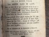 an old book with writing on it sitting on a table