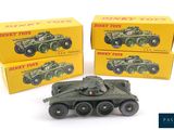 three toy tanks are sitting next to each other on a white surface
