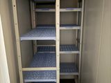 a small room with a shelf and shelves in it
