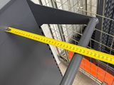a measuring tape that is on the side of a metal shelf