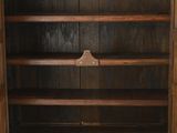 an old wooden cabinet with two shelves and a door