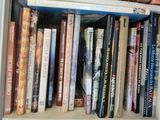 many books that are on a shelf in the room