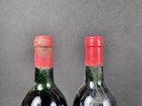 two bottles of wine sitting next to each other on a table
