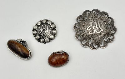three silver and wood brooches, including a brooche, a brooche, and a brooche
