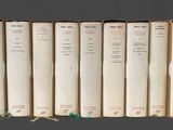 plusieurs vieux livres sont alignés sur une étagère