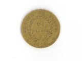 a gold coin on a white surface with a white background