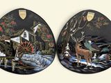 two decorative plates with a picture of a man and a horse