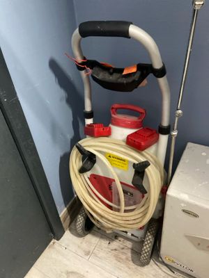 an image of a vacuum and a hose in a room