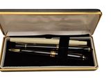 two pens in a box with a gold trim