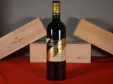 a bottle of wine sitting on a table next to two wooden boxes