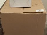 a box sitting on top of a carton in a room