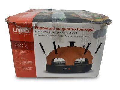 packaging of a pizza oven sitting on top of a cardboard box