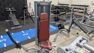 a gym with a lot of machines in the room