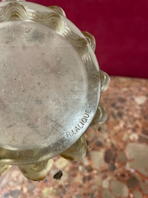a close up of a glass vase on a marble table
