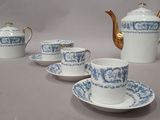 four cups and a teapot on the table