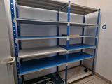 a blue shelf in the corner of a room