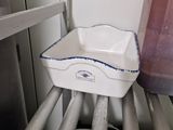 a plastic container sitting on top of a shelf in a kitchen