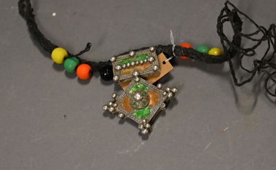 a necklace with a picture of a cross on it