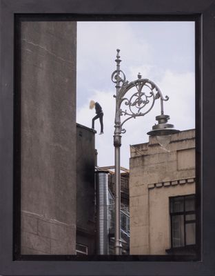 a reflection of a man on a street light