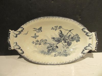 un plat bleu et blanc orné d'oiseaux et de fleurs