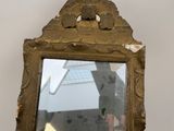 a mirror that has a reflection of a building in it