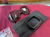 a pair of sunglasses and a pair of gloves on a table