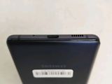 the back of a black cell phone with a barcode on the back of it