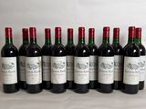 six bottles of wine are lined up on a table