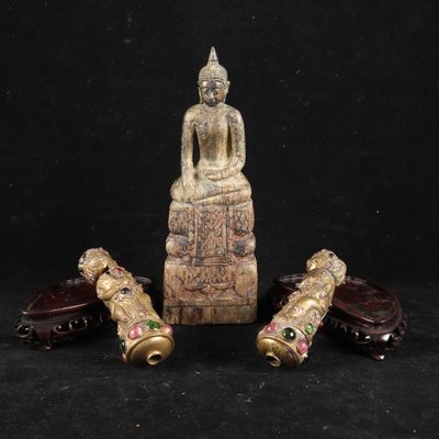 a group of three carved figurines sitting on top of a table