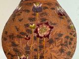 a vase with flowers on it sitting on a table