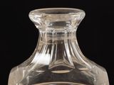 a clear glass bottle with a small amount of liquid in it