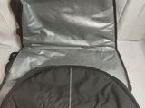 an open suitcase sitting on top of a bed with a white sheet