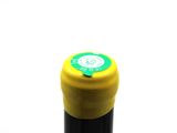 a bottle of wine with a yellow cap on a white background