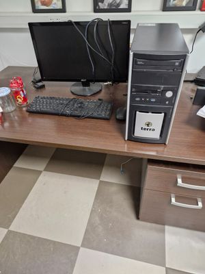 a desktop computer sitting on a desk with a keyboard and a monitor