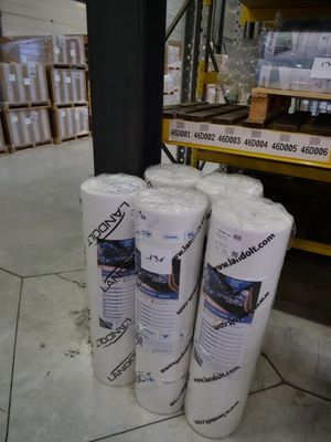 three rolls of toilet paper sitting on the floor in a warehouse