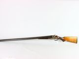 an old rifle with a wooden handle on a white surface