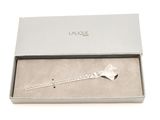 a close up of a bracelet in a box on a white surface