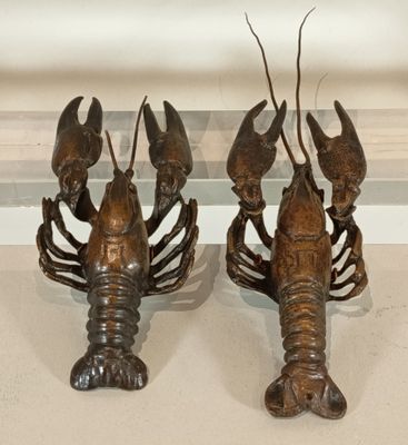 two lobsters that are sitting on a table