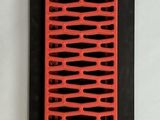 a red and black comb sitting on a white surface
