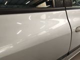 a white car that has a broken door handle on it