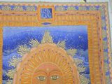 a picture of a painting of a sun on the wall