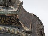 a clock with a statue of a man on top of it