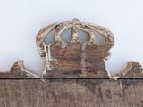 a piece of wood with a crown on top of it