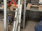 a pile of tools sitting on a shelf in a garage